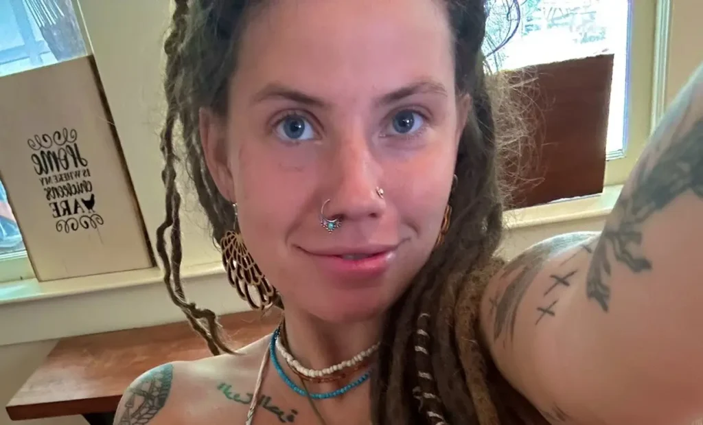 a woman with dreadlocks and tattoos